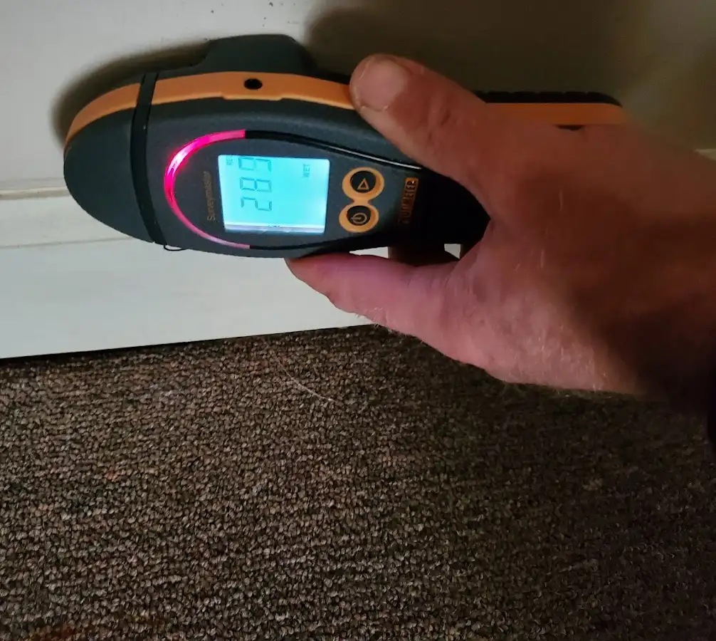 Moisture detection at baseboard during Storm Damage Restoration in Somerville